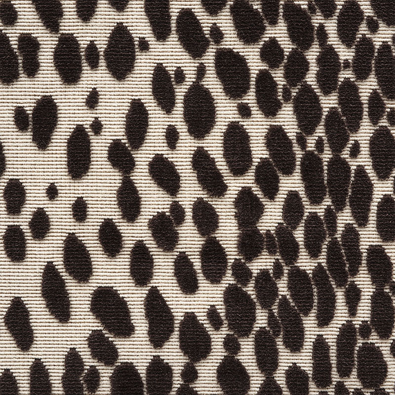 Beige fabric with irregular dark brown leopard spots; classic animal-print textile suitable for apparel or accessories.