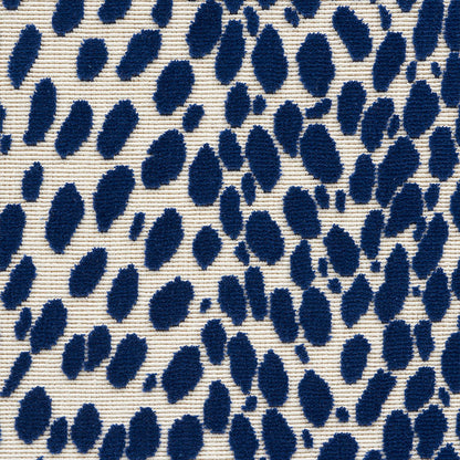 Cream ribbed fabric with navy blue irregular brush-stroke polka dots.
