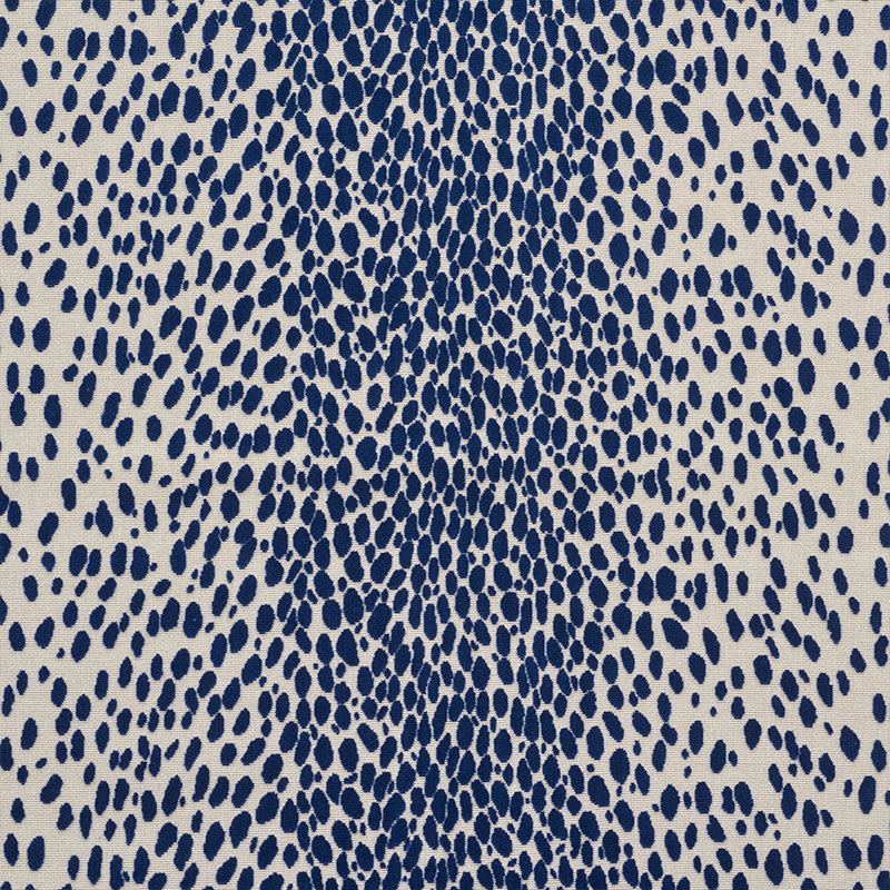 Beige velvet close-up featuring a navy blue irregular dot/teardrop pattern with a denser center.