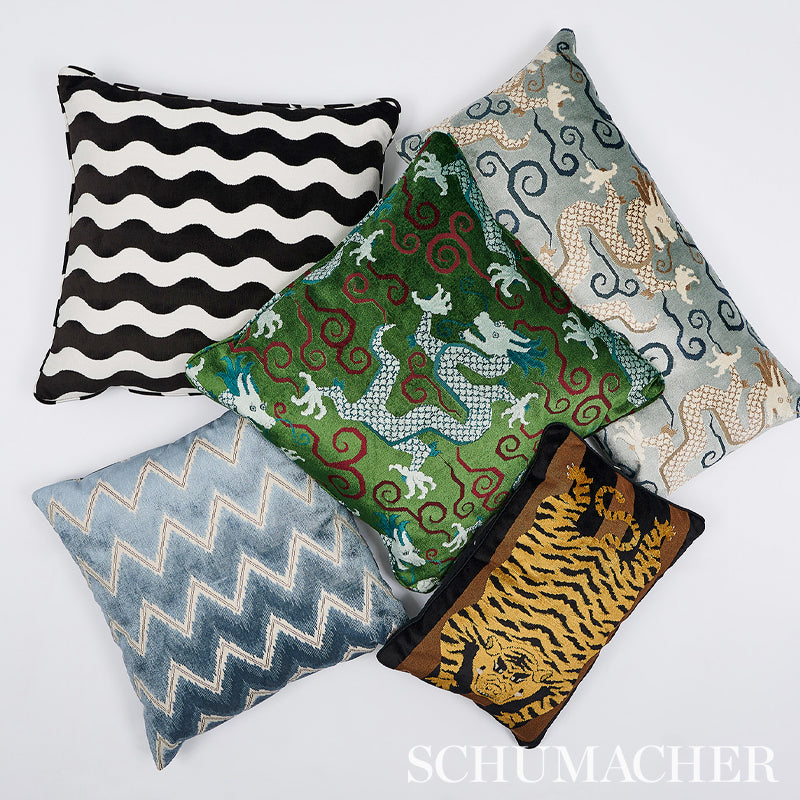 Five rectangular decorative pillows in black-white zigzag, blue chevron, green damask with red swirls, gray swirls, and tiger print.