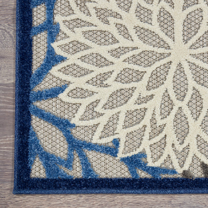 Rectangular woven rug with off-white field, tan leaf lattice motif, & bold navy blue border, 3' x 4'.