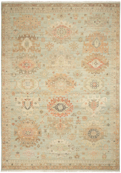 Pastel-toned oriental rug with medallion motifs in blues, pinks, ivories; fringed edges, vintage faded look.