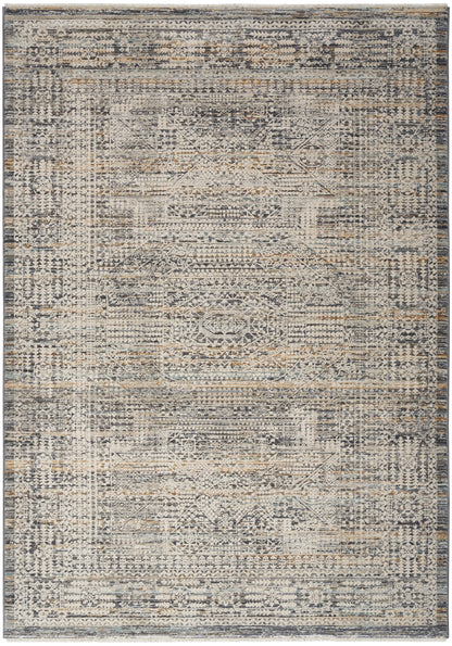 Distressed vintage-style area rug in gray, navy, and beige with a faded geometric medallion pattern and ornate border.