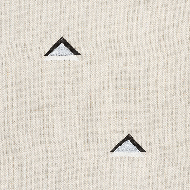 Beige linen fabric backdrop with two small black-outlined blue triangles, minimalist geometric accents.