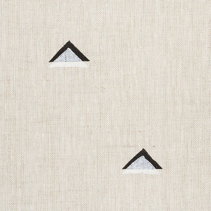 Beige linen fabric backdrop with two small black-outlined blue triangles, minimalist geometric accents.