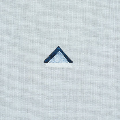 Tiny overlapping navy and white triangle print on sky-blue background.