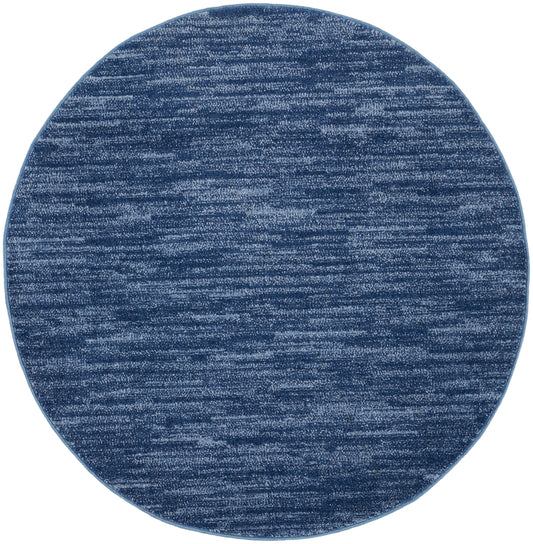 Round blue rug with heathered navy & lighter blue fibers; soft woven texture.