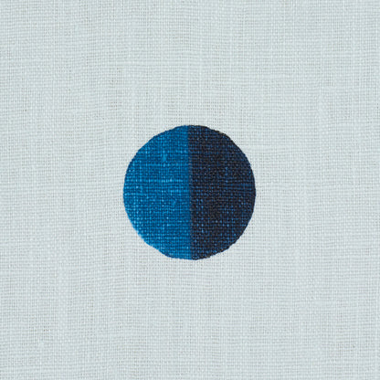 Circular two-tone dot: left bright blue, right dark navy on sky blue background; minimalist geometric textile print.