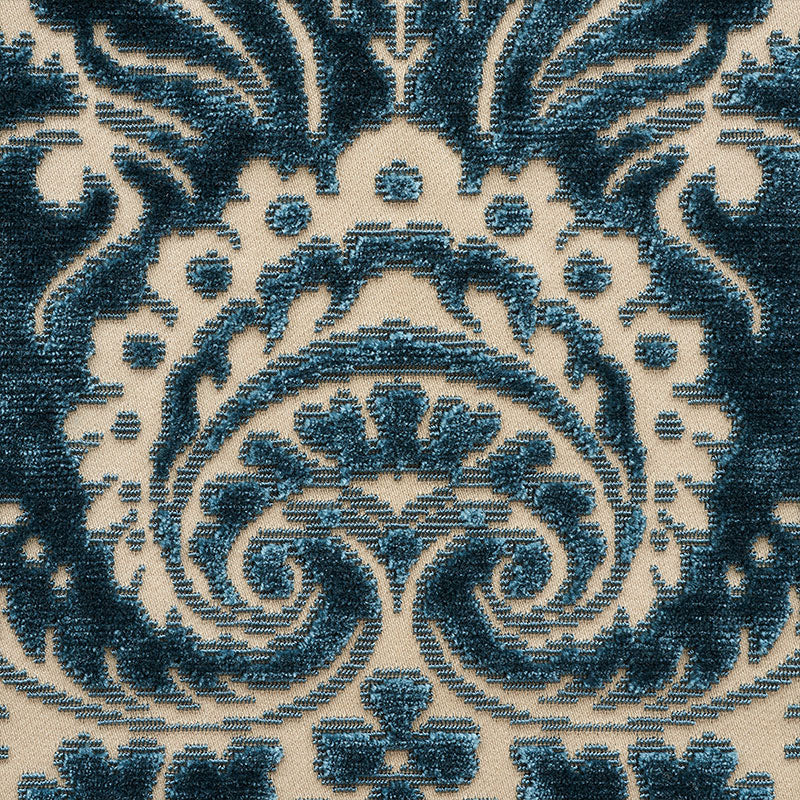 Grey velvet panel centered on a blue and cream ornate rug.