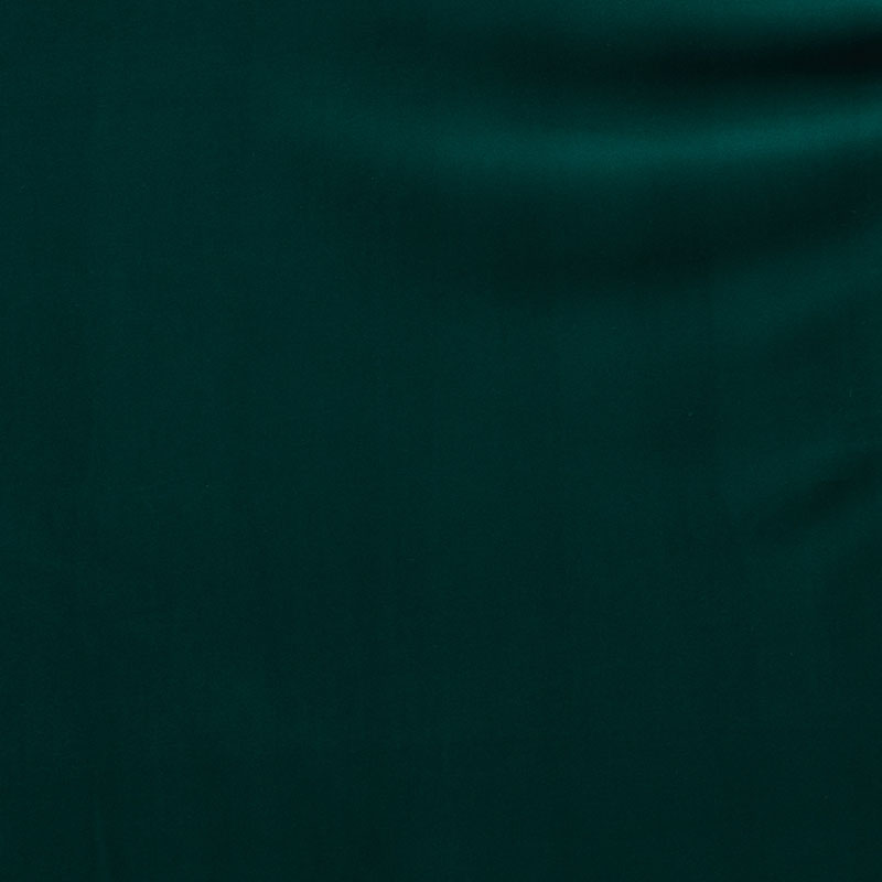 Deep green velvet fabric swatch with subtle sheen and soft drape.