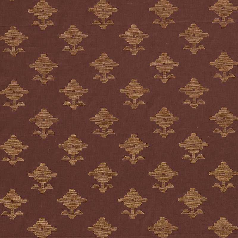 Brown fabric with a repeating gold geometric floral motif pattern.