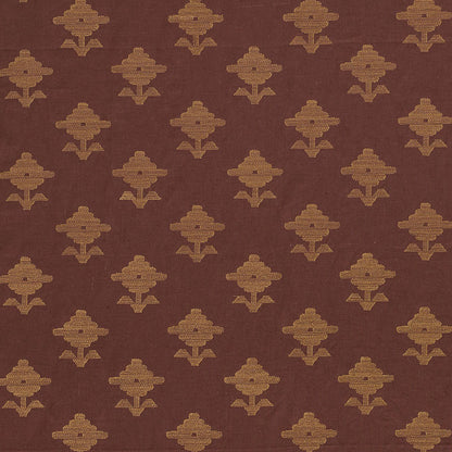 Brown fabric with a repeating gold geometric floral motif pattern.