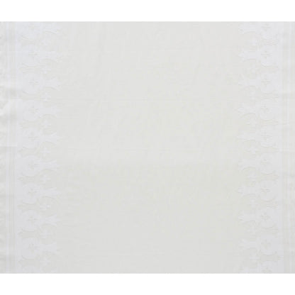 Ivory linen table runner with subtle embossed floral border along the sides.