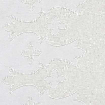 White fabric with tonal applique embroidery of flowing leaf shapes and small flower motifs