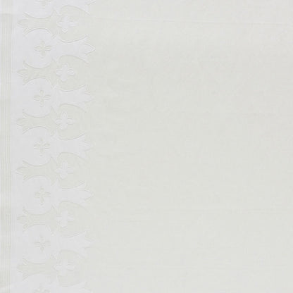 White embossed wallpaper border with vertical floral scroll design along the left edge on a cream textured background.