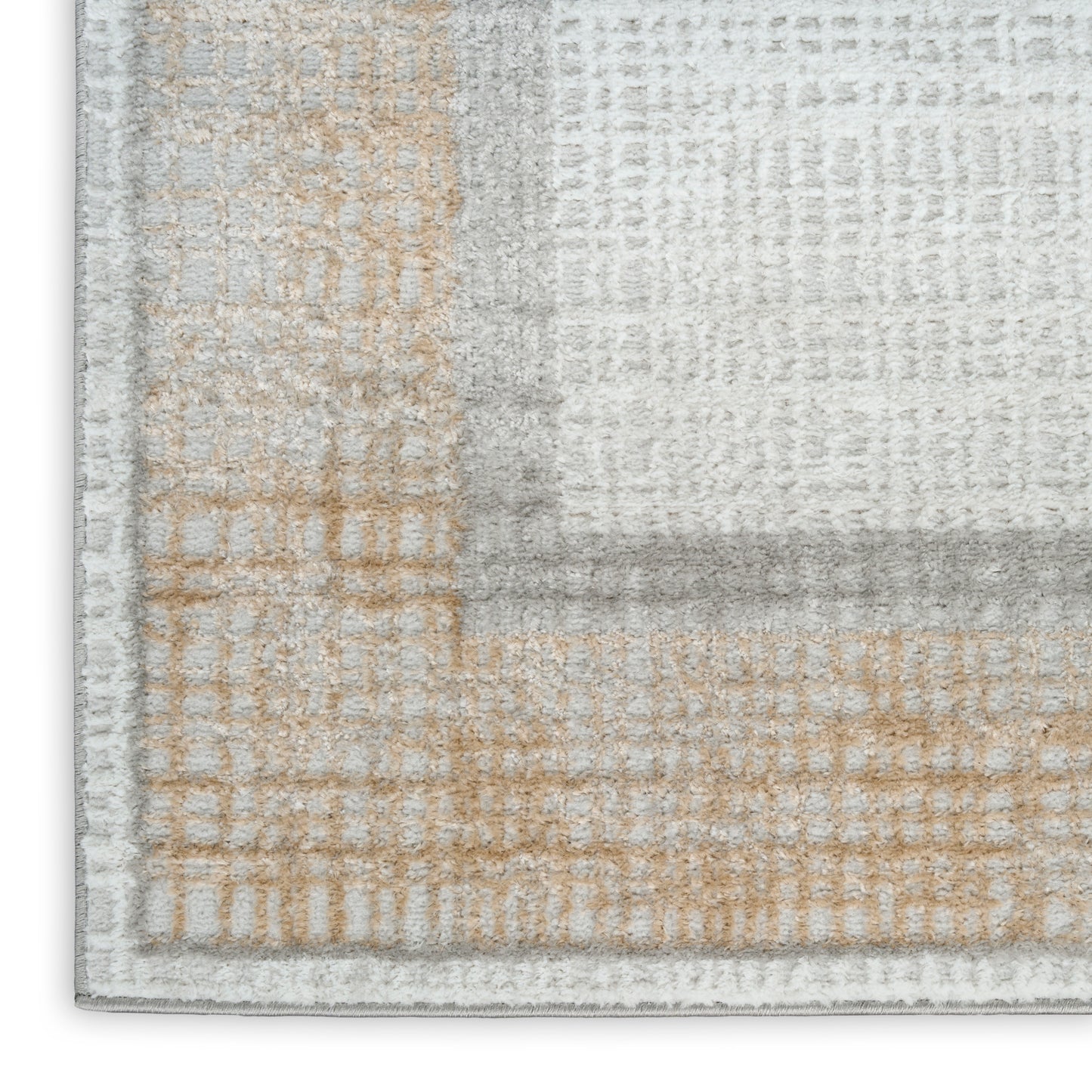 Neutral patchwork area rug in gray, beige and cream with a soft textured pile; modern geometric blocks for living rooms.