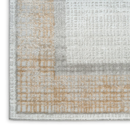 Neutral patchwork area rug in gray, beige and cream with a soft textured pile; modern geometric blocks for living rooms.