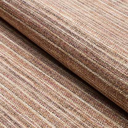 Rolled brown striped woven fabric rug with earthy beige and tan tones and a textured weave.