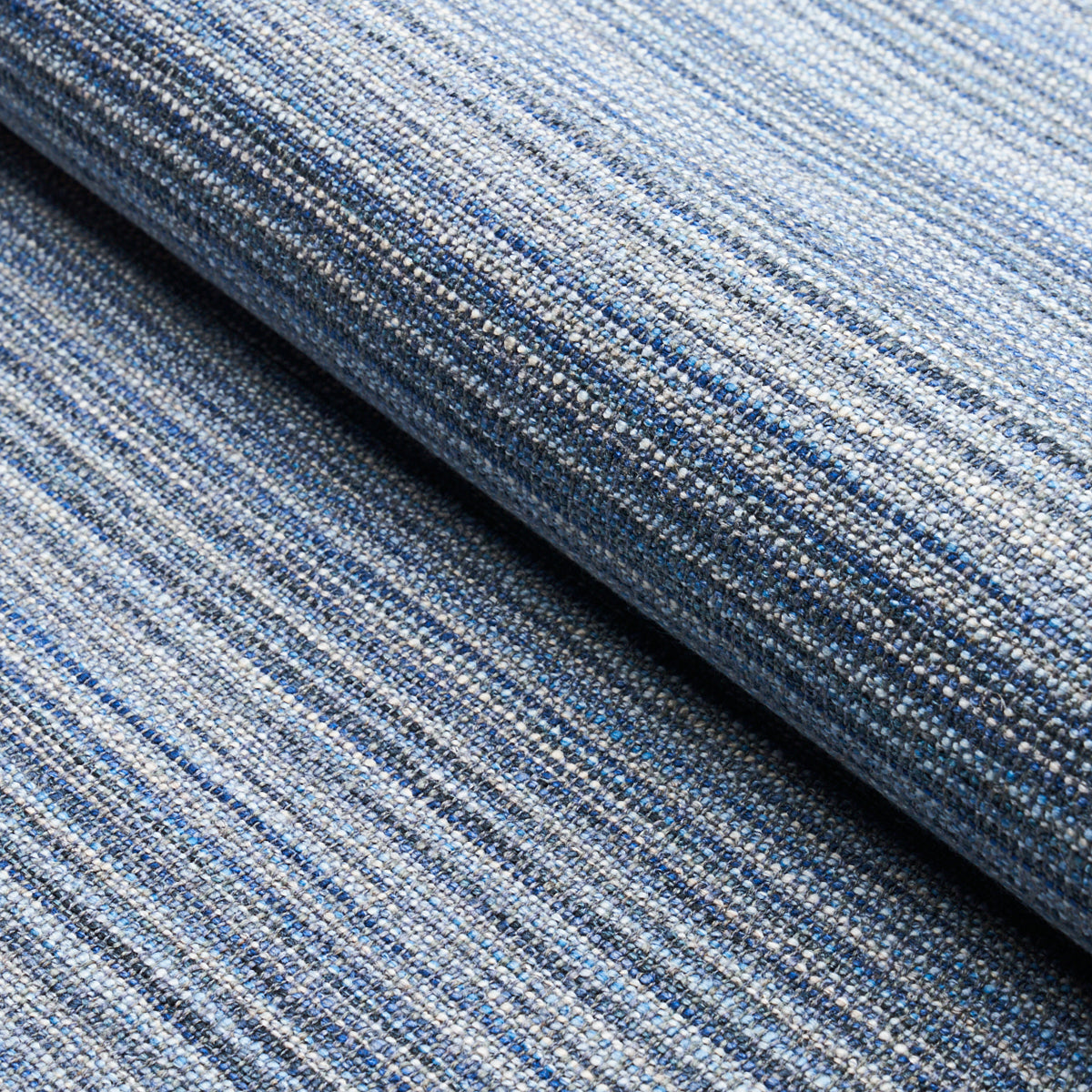 Blue striped woven fabric roll with textured denim-toned yarns; upholstery or crafts.