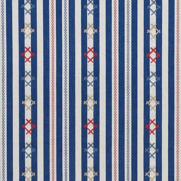 Vertical blue and white striped fabric with decorative red and light-blue X-shaped motifs and diamonds.