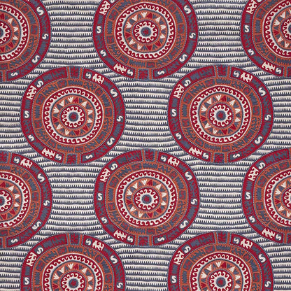 Bold circular mandala motifs in red, blue and white on a navy striped background.