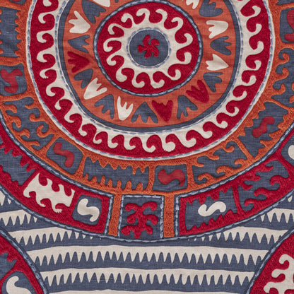 Circular mandala rug in red, orange, blue and white; boho textile for floor or wall decor.