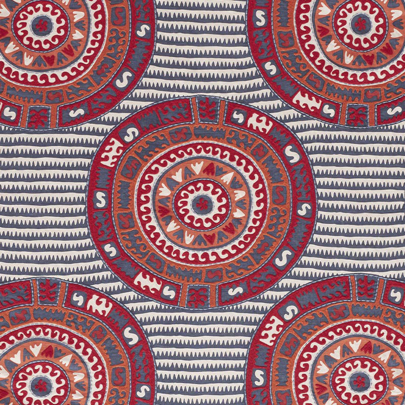 Circular mandala medallions in red, orange and blue on a navy striped background.