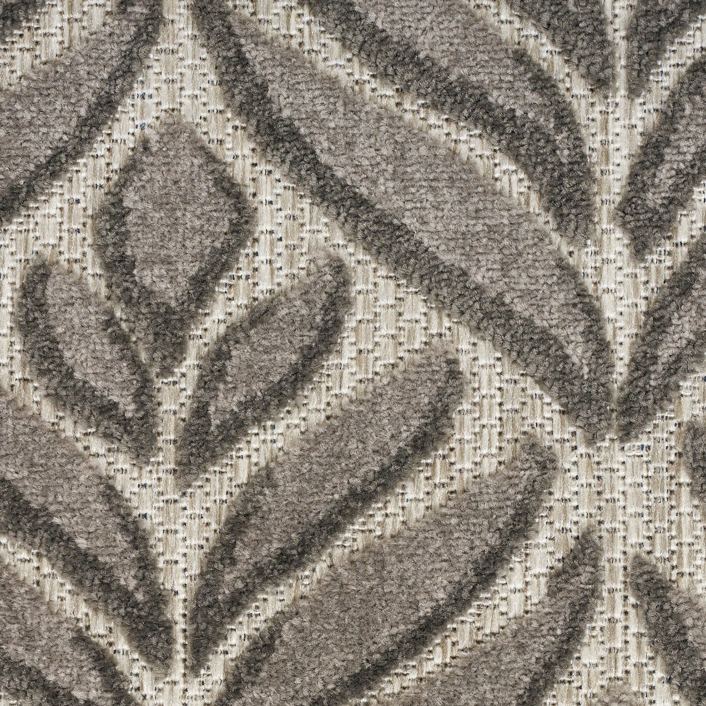 Beige round rug with raised taupe leaf motifs and plush woven pile for modern botanical decor.