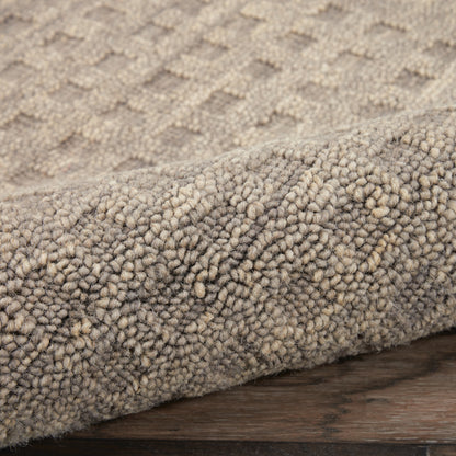 Beige high-pile shag runner rug with dense boucle texture and rolled edge on wood floor