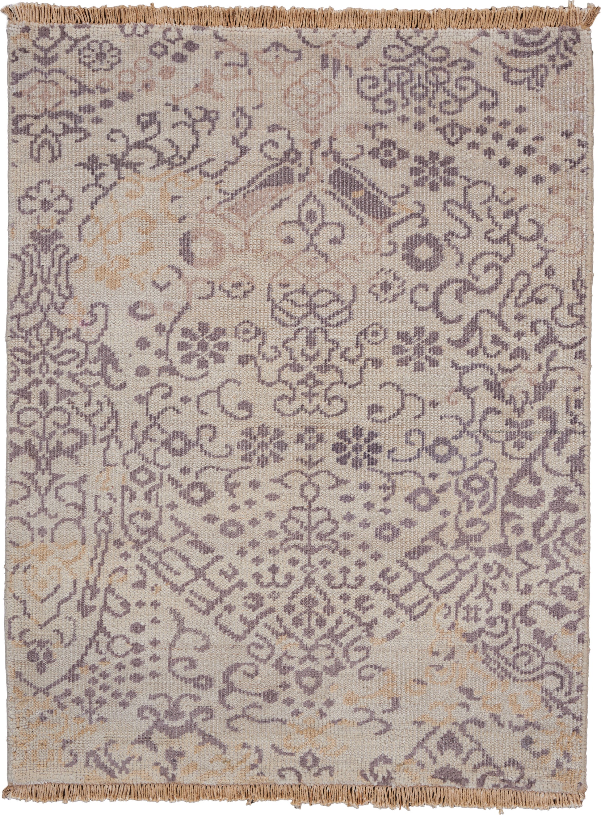 Beige rug with lavender damask floral pattern and fringed edges.