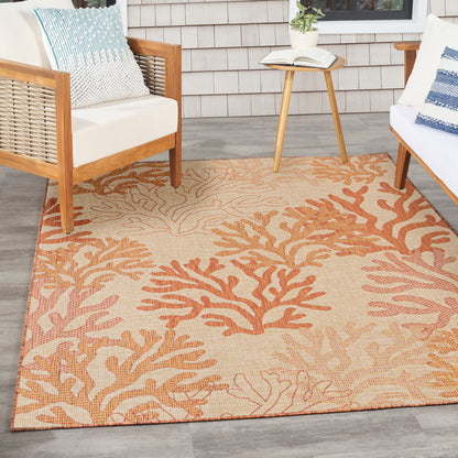 Rectangular beige outdoor rug with orange coral reef pattern; woven texture for patio seating.