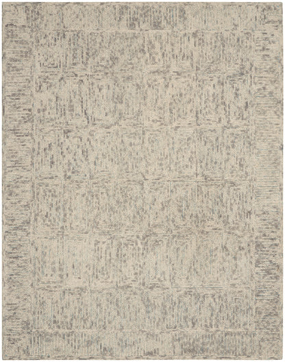 Neutral beige and gray area rug with a geometric lattice pattern and border; rectangular, cozy living-room style.