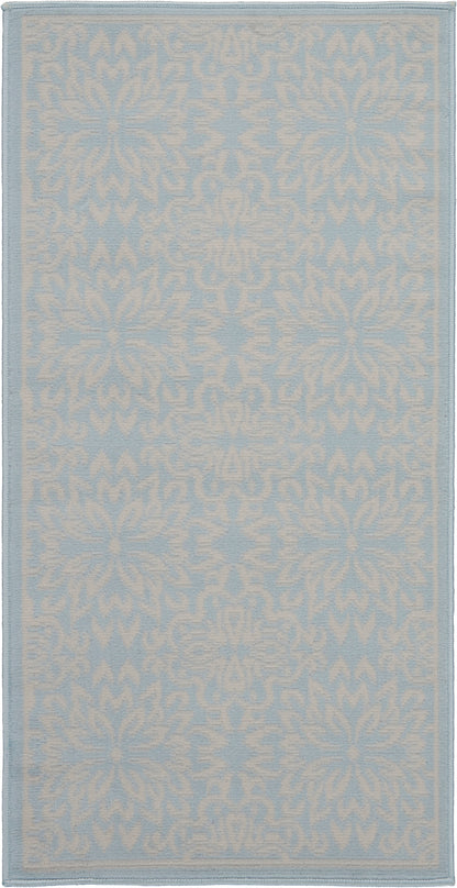 Pale blue rug with a white damask floral motif; rectangular rug with a matching border.