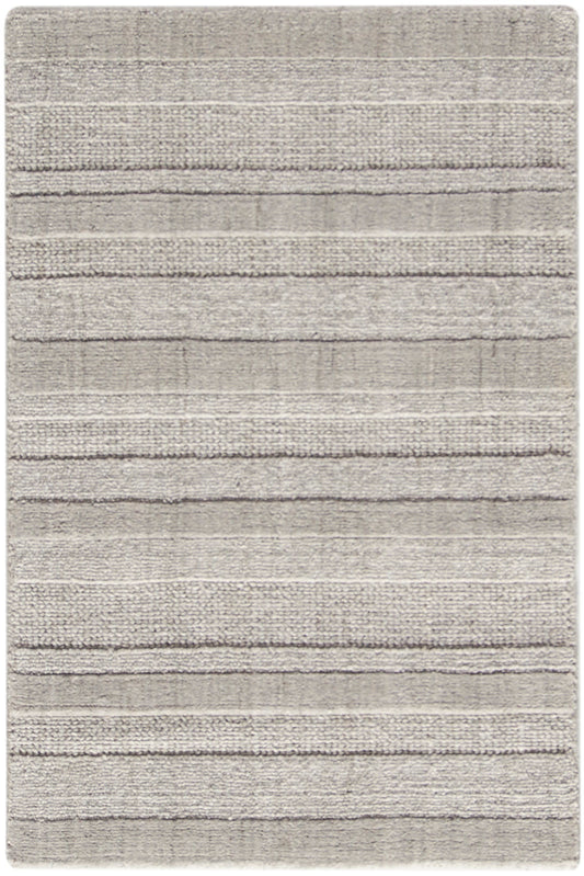 Light gray shag rug with plush texture and horizontal stripes; rectangular, modern living room decor.