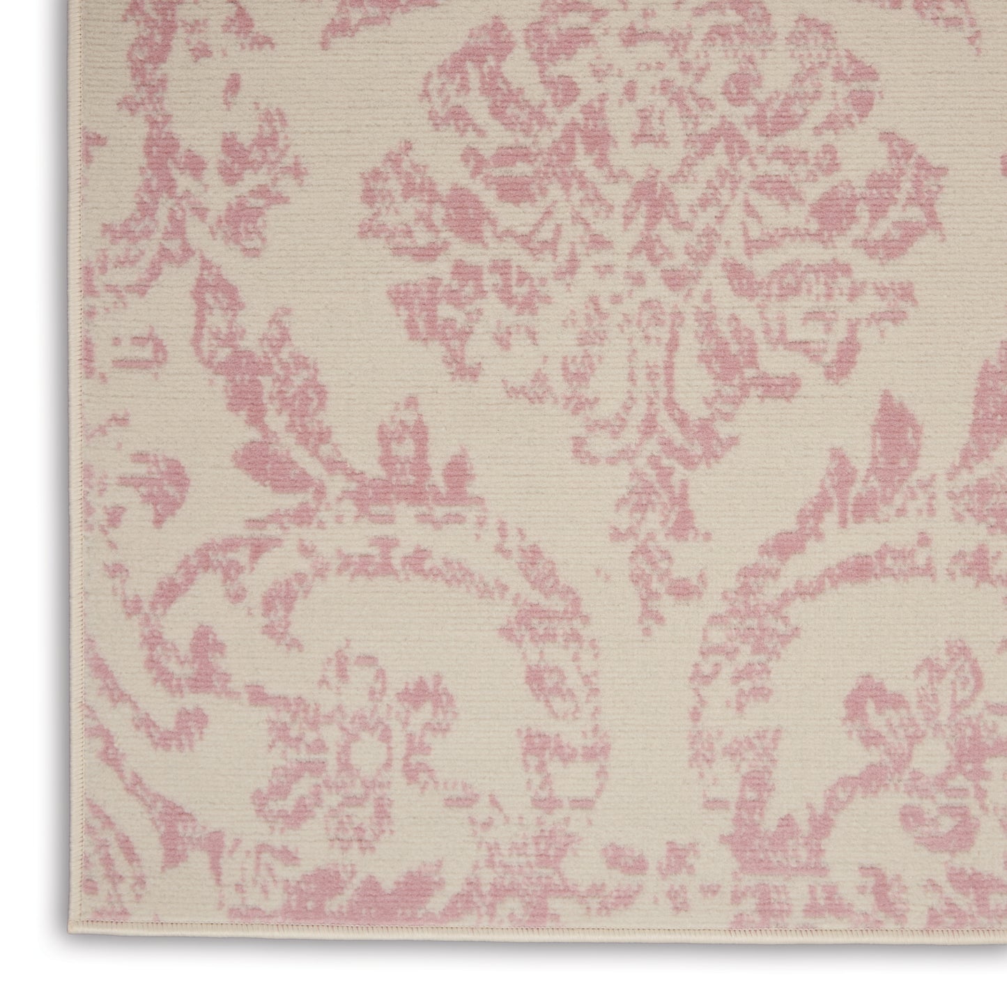 Beige rug with pink damask floral scrolling pattern; woven jacquard texture.