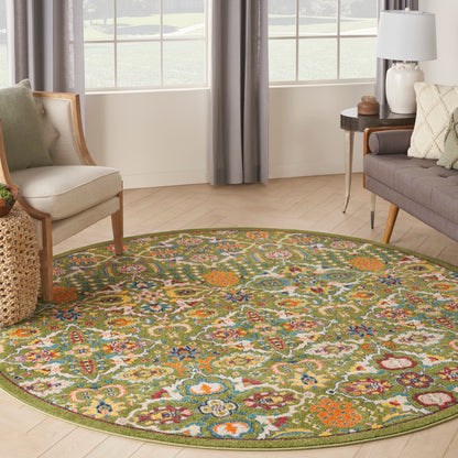 Round olive-green bordered boho floral rug with multicolor blossoms in a light living room.