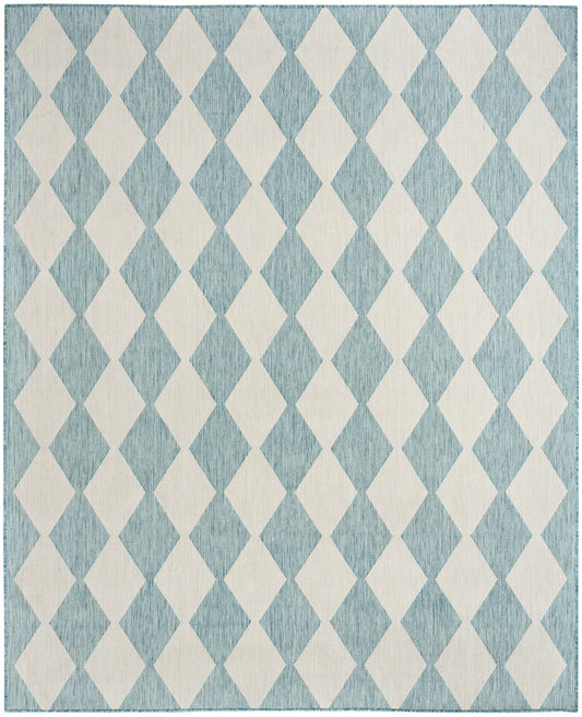 Rectangular woven rug with teal background and ivory diamond harlequin pattern; coastal, casual decor.