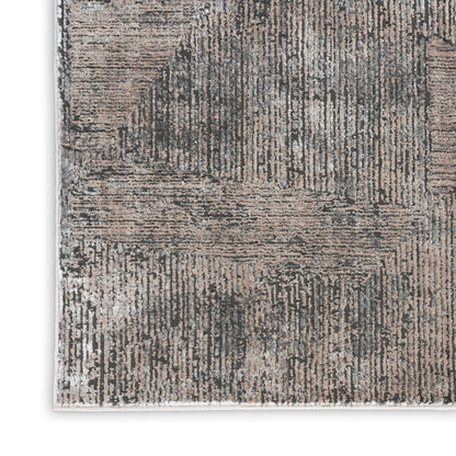 Rectangular gray and taupe area rug with a distressed abstract linear pattern and soft woven texture.