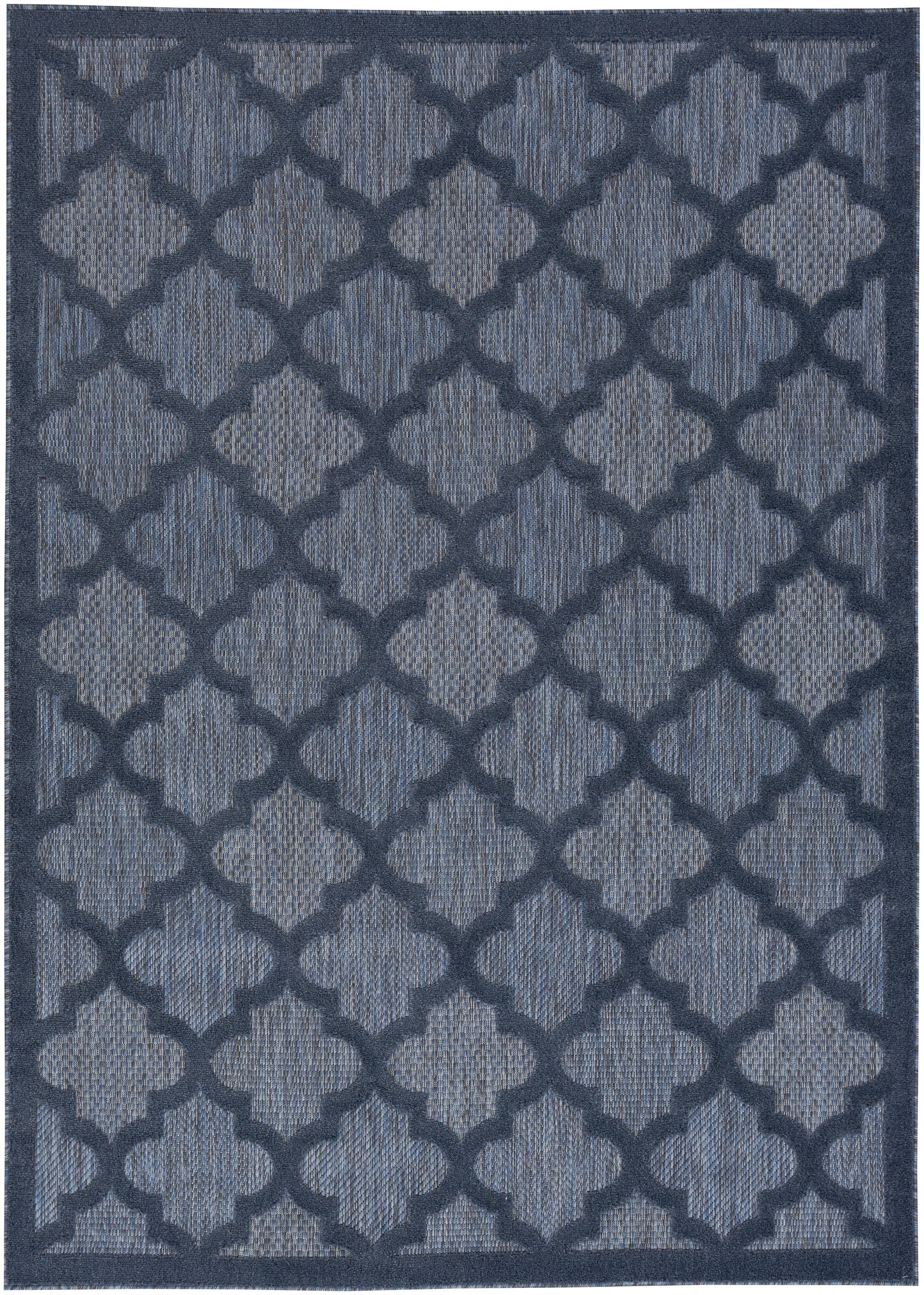 Navy blue area rug featuring a repeating quatrefoil lattice pattern in lighter blue with a textured woven look.