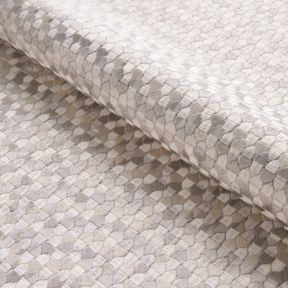 Beige-gray embroidery fabric with a small geometric hex pattern, rolled edge, suitable for upholstery or drapery.