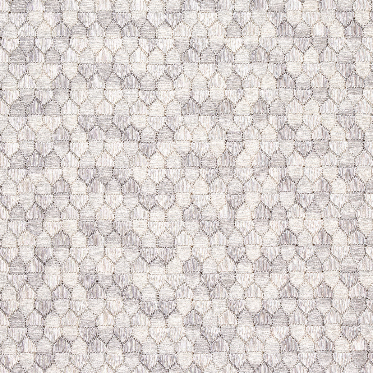 Beige and taupe woven fabric with a repeating hollow oval lattice pattern; delicate upholstery or drapery textile.