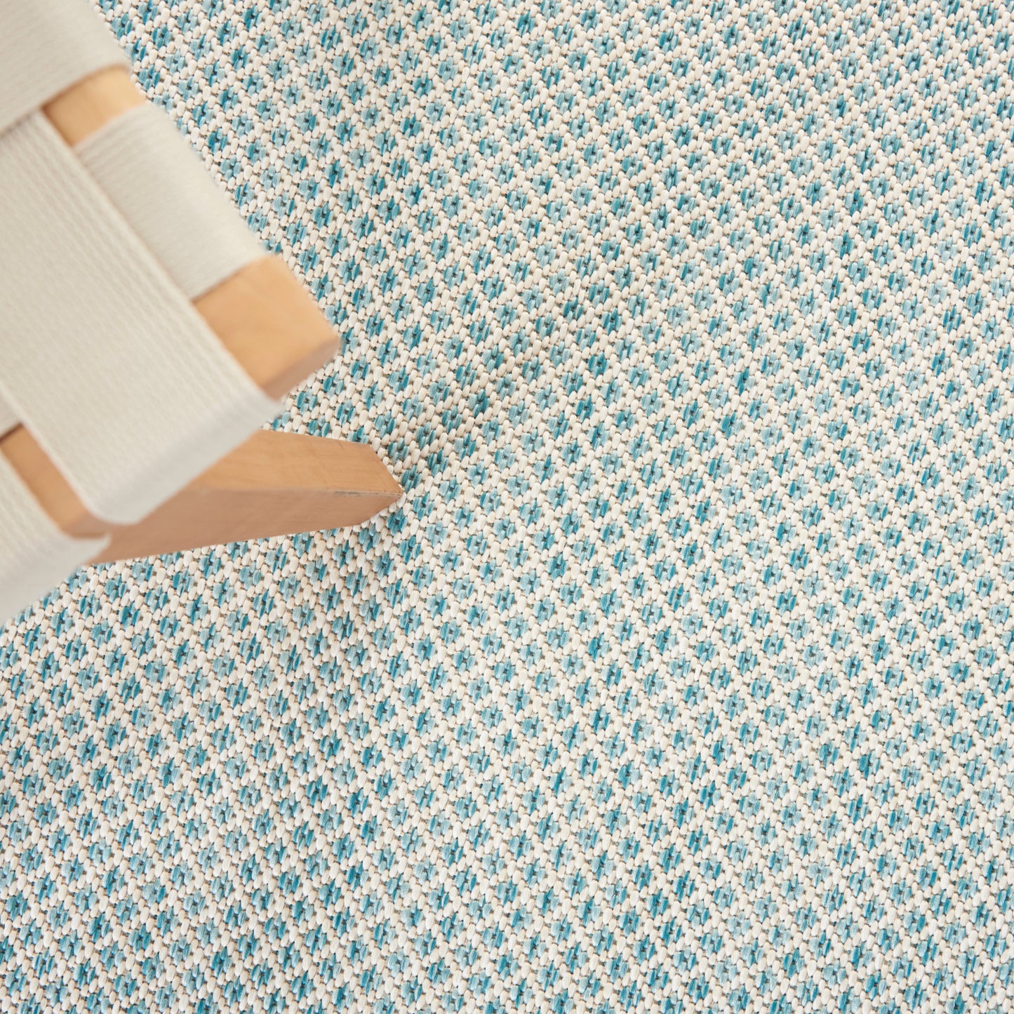Close-up of a blue-and-white woven modern rug showing texture and a geometric pattern; 8' x 10'.