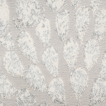 Light gray rug with cream raised leaf-like pattern and plush tufted pile.