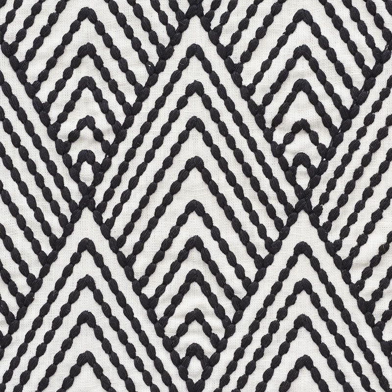 Close-up of black rope-textured chevron pattern on white fabric, bold geometric textile for upholstery.