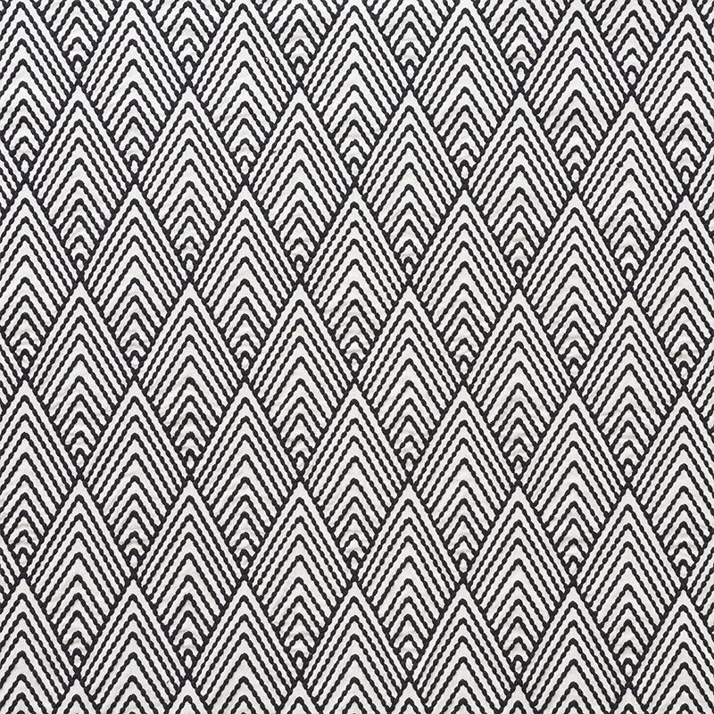 Black and white geometric diamond chevron fabric; woven textile with repeating V-shaped motifs.