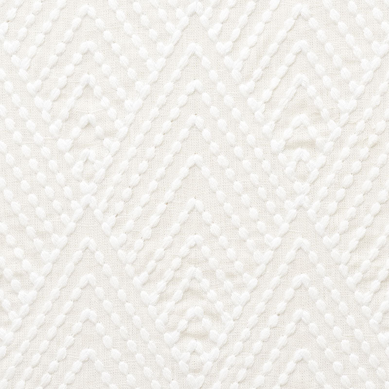 Ivory embroidery fabric with raised dotted chevron pattern and geometric diamond motifs.