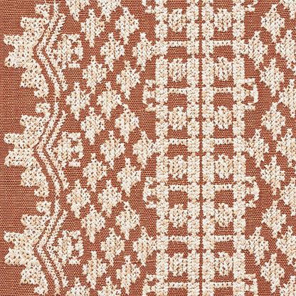 Rust-red woven rug with ivory geometric floral pattern; traditional kilim-inspired textile.
