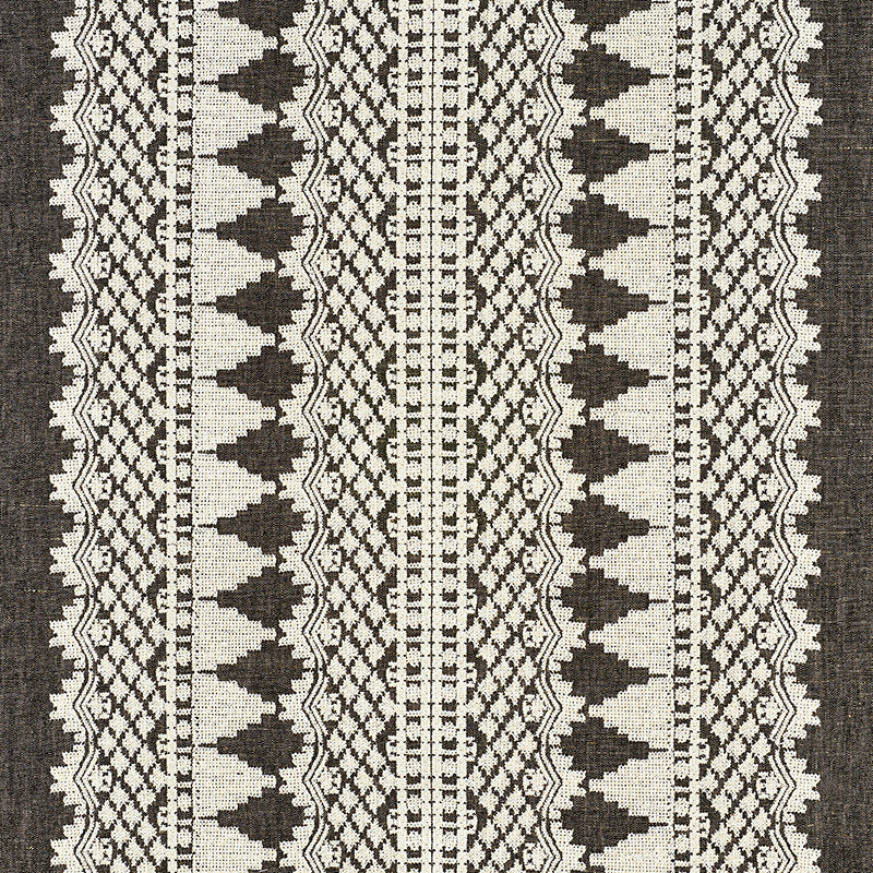 Black and cream woven kilim rug with vertical stripes and geometric diamond motifs.