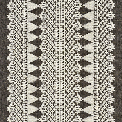 Black and cream woven kilim rug with vertical stripes and geometric diamond motifs.