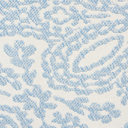 Light blue damask woven pattern on fabric with floral motifs.